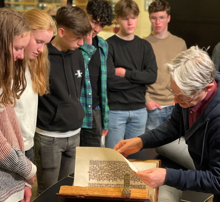 Students looking at the real medieval manuscript at the Dutch Royal Library